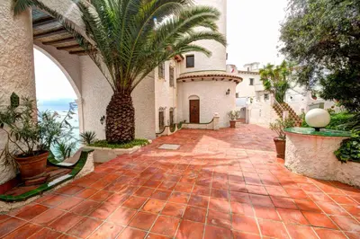 a courtyard of a house with a palm tree at The Magic Sea Front by Hello Homes Sitges in Sitges