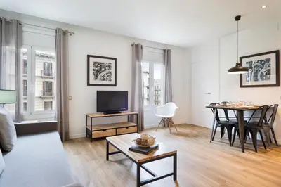 a living room with a tv and a table at Amister Apartments in Barcelona