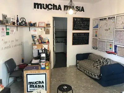 a room with a couch and a desk in a room at Mucha Masia Hostel Rural Urba in El Prat de Llobregat