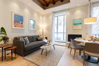 a living room with a couch and a table at Aspasios Urquinaona Apartments in Barcelona