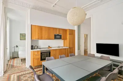 a kitchen and dining room with a table and chairs at Aspasios Urquinaona Apartments in Barcelona