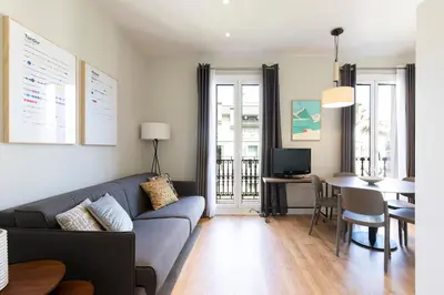 a living room with a couch and a table at Aspasios Urquinaona Apartments in Barcelona