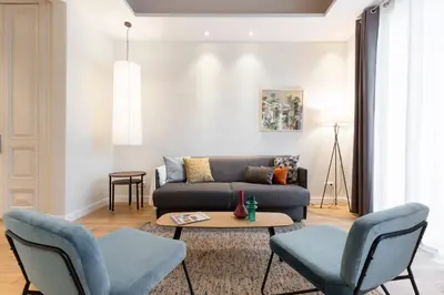 a living room with a couch and chairs at Aspasios Urquinaona Apartments in Barcelona