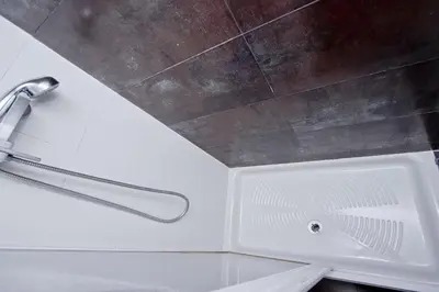 a white bath tub with a shower head in a bathroom at Barcelona City Apartment in Barcelona