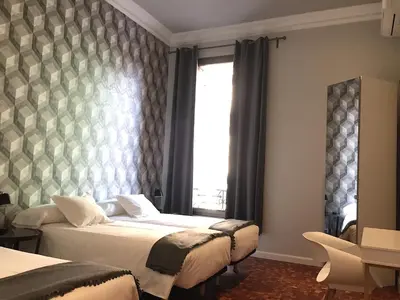 a bedroom with two beds and a window at Hip Karma Hostel in Barcelona
