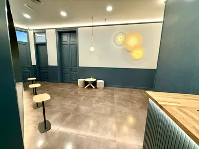 a room with two stools and lights on the wall at Hip Karma Hostel in Barcelona