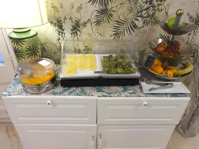 a counter with a tray of fruits and vegetables on it at Hotel Lloret Ramblas in Barcelona