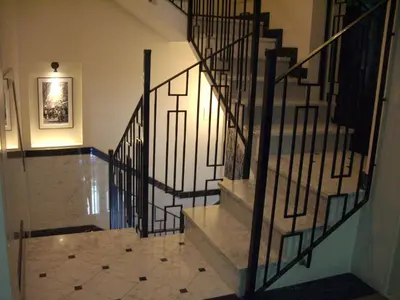 a staircase with a metal railing in a building at Hotel Lloret Ramblas in Barcelona