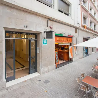 a store with an open door on a street at BcnStop Sagrada Familia in Barcelona