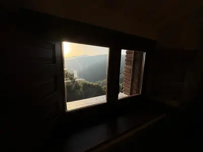 a window in a room with a view of a mountain at Can Rovira de Fogars in Montseny