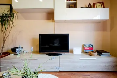 a living room with a television on a table at Three Bedroom Apartment in Sants in Barcelona
