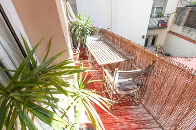 a balcony with tables and chairs and a fence at Three Bedroom Apartment in Sants in Barcelona