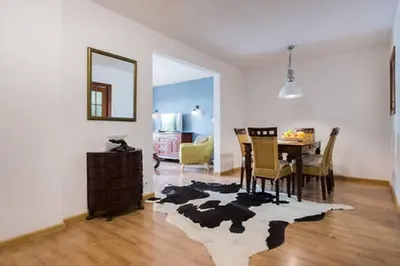 a living room with a table and a dining room at 3 bedroom Apartment with private garden on top location Sitges centre beach in Sitges