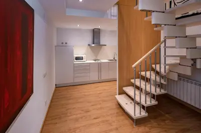 a staircase in a room with a kitchen and a kitchenasteryasteryasteryasteryastery at Apartments Playa de Castelldefels in Castelldefels