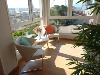 a room with two chairs and a table and windows at Hotel 1948 Manresa in Manresa