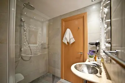 a bathroom with a sink and a shower at Tendency Sagrada Familia Deluxe in Barcelona