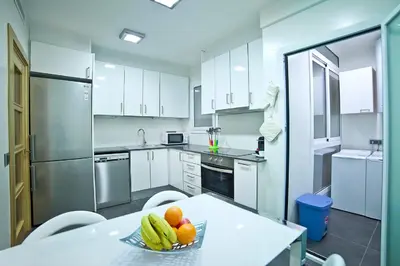 a kitchen with a bowl of fruit on a table at Tendency Sagrada Familia Deluxe in Barcelona