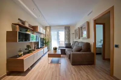 a living room with a couch and a television at Tendency Sagrada Familia Deluxe in Barcelona