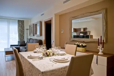 a dining room with a table and a mirror at Tendency Sagrada Familia Deluxe in Barcelona