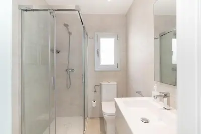 a bathroom with a shower and a toilet and a sink at Beach penthouse Sitges Rentals in Sitges