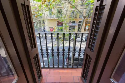 an open door to a balcony with a wrought iron gate at ApartEasy - Sant Antoni Market in Barcelona