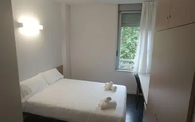 a bedroom with a bed with two stuffed animals on it at Residencia Universitaria Resa Roberto de Nobili in Sant Cugat del Vallès