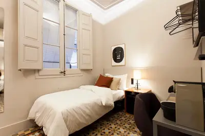 a bedroom with a bed and a window at DestinationBCN - Universitat Rooms in Barcelona