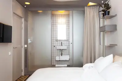 a hotel room with a bed and a bathroom at DestinationBCN - Universitat Rooms in Barcelona