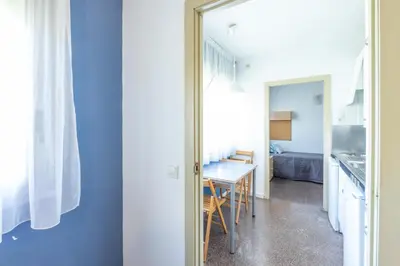 a kitchen and dining room with a table and a mirror at Residencia Universitaria Resa La Ciutadella in Barcelona