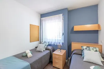a bedroom with two beds and a window at Residencia Universitaria Resa La Ciutadella in Barcelona