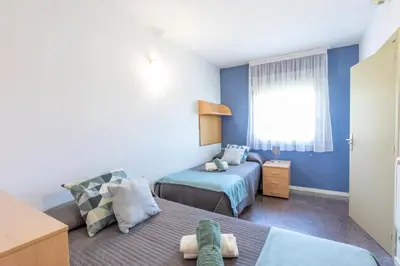 a bedroom with two beds and a window at Residencia Universitaria Resa La Ciutadella in Barcelona