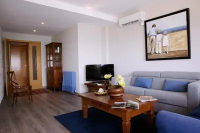 a living room with a couch and a table at Great Sea-Side Barcelona Apartment in Badalona