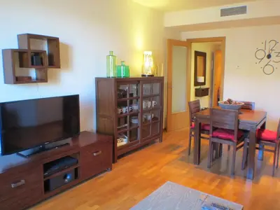 a living room with a dining table and a television at Barcelona4Seasons - Central Palace in Barcelona
