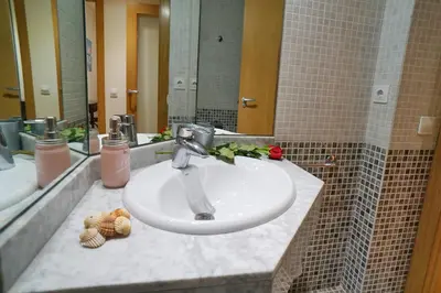 a bathroom with a sink and a mirror at Barcelona4Seasons - Central Palace in Barcelona