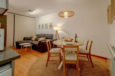 a living room with a table and a couch at Capricho Apartamento Sitges in Sitges