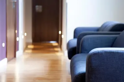 a row of blue chairs in a room with a wooden floor at Hostal BCN Ramblas in Barcelona