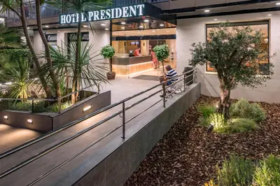 a person sitting in the lobby of a building at Hotel President in Calella