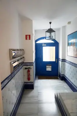 a room with a blue door and a fire hydrant at Love Sitges & Beach in Sitges