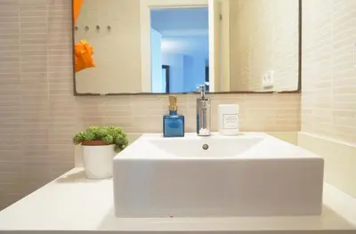 a white sink in a bathroom with a mirror at Love Sitges & Beach in Sitges