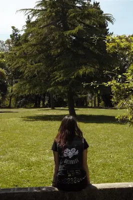 a woman sitting on a bench in a park at Cova Safaja in San Quírico Safaja