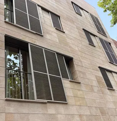 a building with shuttered windows on the side of it at Hostal Rambla in Sant Boi del Llobregat