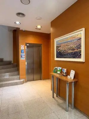 a lobby with a desk and a painting on the wall at Hostal Rambla in Sant Boi del Llobregat