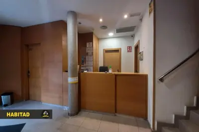 a lobby with a reception desk in a building at Hostal Rambla in Sant Boi del Llobregat