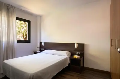 a bedroom with a white bed and a window at SG Marina 54 Apartments in Castelldefels