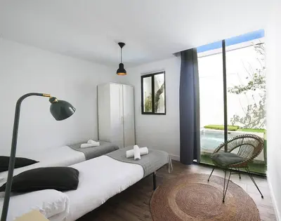a bedroom with two beds and a large window at Fridays Flats Casa Lavander in Barcelona