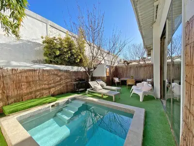 a backyard with a swimming pool and a patio at Fridays Flats Casa Lavander in Barcelona