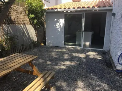 a picnic bench sitting outside of a house at Villa Masnou Homelydays in El Carrer del Canonge