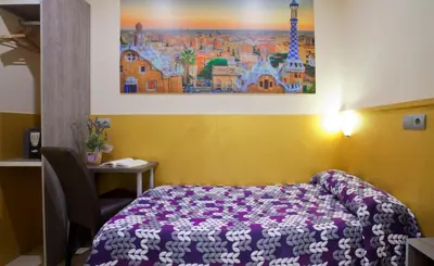 a room with a bed and a painting on the wall at Hostal Barcelona in Barcelona