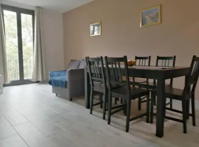 a living room with a table and chairs and a bed at Diagonal Apartments in Barcelona