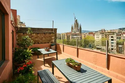 a balcony with two tables and a view of a city at Diagonal Apartments in Barcelona